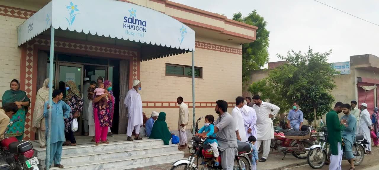 The entrance of the Salma Khatoon Healthcare Center on Western Road, Sahiwal, with patients and families arriving